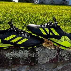 Black and flourescent yellow Adidas soccer cleats